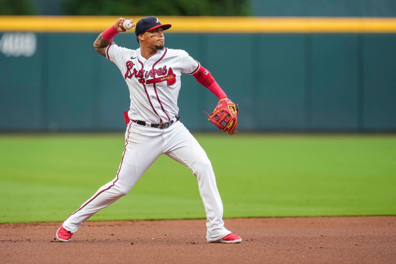 Aug 15, 2023; Cumberland, Georgia, USA; Atlanta Braves shortstop Orlando Arcia (11) throws out New York Yankees right fielder Aaron Judge (99) (not shown) after fielding a ground ball during the first inning at Truist Park. Mandatory Credit: Dale Zanine-USA TODAY Sports