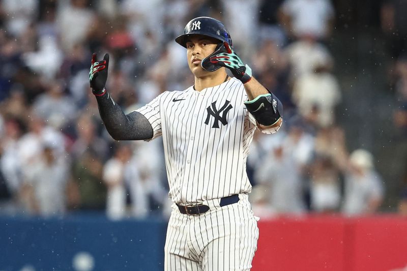 Jun 22, 2024; Bronx, New York, USA;  New York Yankees designated hitter Giancarlo Stanton (27) gestures after hitting a double against the Atlanta Braves in the fourth inning at Yankee Stadium. Mandatory Credit: Wendell Cruz-USA TODAY Sports