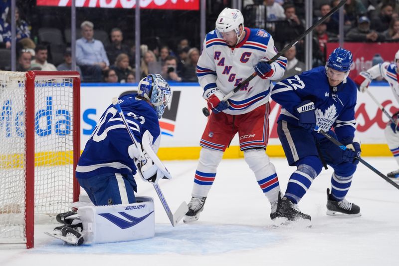 Mar 25, 2026; Toronto, Ontario, CAN; New York Rangers forward J.T. Miller (8) defelcts the puck at Toronto Maple Leafs goaltender Joseph Woll (60) as defenseman Jake McCabe (22) helps defend during the second period at Scotiabank Arena. Mandatory Credit: John E. Sokolowski-Imagn Images Mar 25, 2026; Toronto, Ontario, CAN; New York Rangers forward J.T. Miller (8) defelcts the puck at Toronto Maple Leafs goaltender Joseph Woll (60) as defenseman Jake McCabe (22) helps defend during the second period at Scotiabank Arena. Mandatory Credit: John E. Sokolowski-Imagn Images