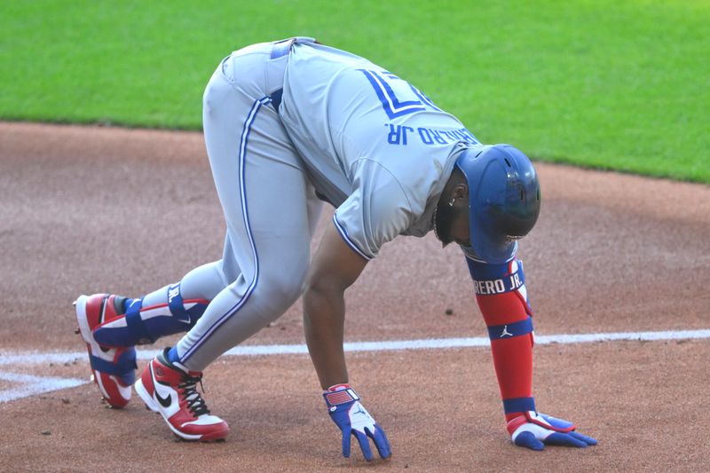 Jun 21, 2024; Cleveland, Ohio, USA; Toronto Blue Jays first baseman Vladimir Guerrero Jr. (27) reacts after he was hit by a foul ball in the first inning against the Cleveland Guardians at Progressive Field. Mandatory Credit: David Richard-USA TODAY Sports