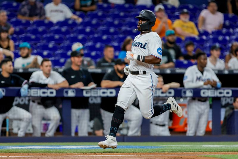 Jun 21, 2023; Miami, Florida, USA; Miami Marlins center fielder Jonathan Davis (49) runs toward home plate and scores after an RBI single from third baseman Garrett Hampson (not pictured) against the Toronto Blue Jays during the seventh inning at loanDepot Park. Mandatory Credit: Sam Navarro-USA TODAY Sports