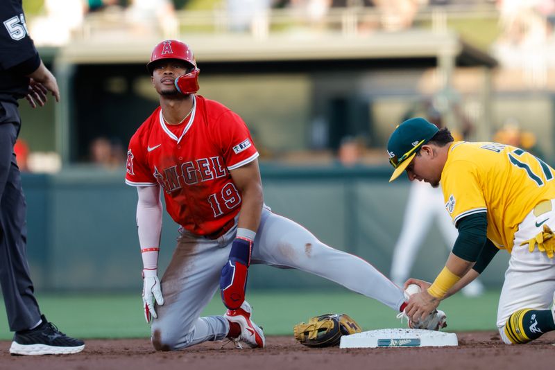 May 20, 2025; West Sacramento, California, USA; Los Angeles Angels pitcher Yusei Kikuchi (16) avoids the tag by Athletics second baseman Luis Urías (17) to steal second base during the third inning at Sutter Health Park. Mandatory Credit: Sergio Estrada-Imagn Images
