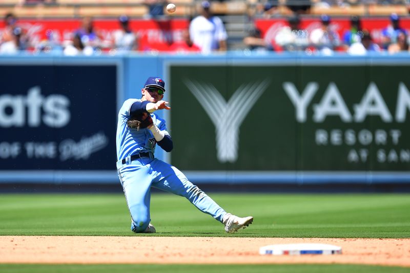 Jul 26, 2023; Los Angeles, California, USA; Toronto Blue Jays second baseman Cavan Biggio (8) is late on the throw to first against Los Angeles Dodgers second baseman Enrique Hernandez (8) during the fourth inning at Dodger Stadium. Mandatory Credit: Gary A. Vasquez-USA TODAY Sports