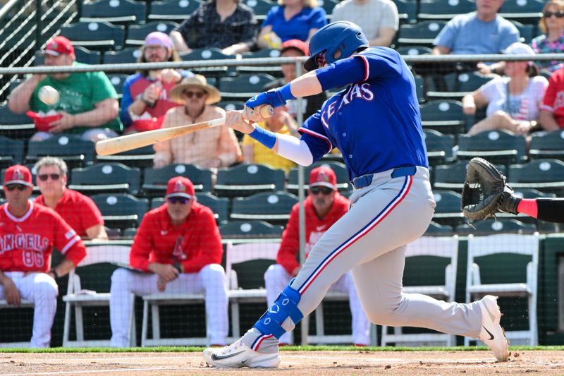 Feb 23, 2026; Tempe, Arizona, USA;  Texas Rangers catcher Danny Jansen (9) hits a two-run home run in the first inning against the Los Angeles Angels during a spring training game at Tempe Diablo Stadium. Mandatory Credit: Matt Kartozian-Imagn Images