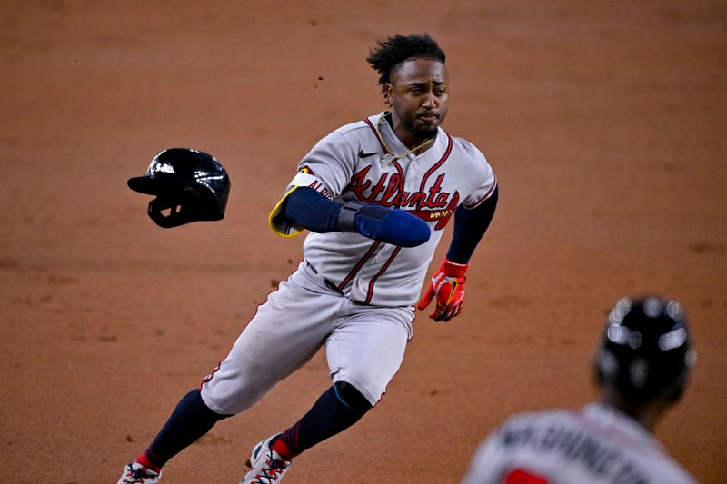 May 16, 2023; Arlington, Texas, USA; Atlanta Braves second baseman Ozzie Albies (1) scores a run from second base during the second inning against the Texas Rangers at Globe Life Field. Mandatory Credit: Jerome Miron-USA TODAY Sports