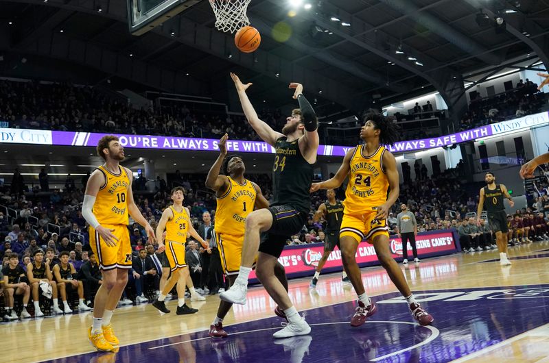 Jan 28, 2023; Evanston, Illinois, USA; Minnesota Golden Gophers forward Joshua Ola-Joseph (1) and Northwestern Wildcats center Matthew Nicholson (34) go for the ball during the second half at Welsh-Ryan Arena. Mandatory Credit: David Banks-USA TODAY Sports