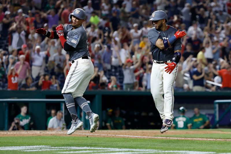 Aug 12, 2023; Washington, District of Columbia, USA; Washington Nationals catcher Keibert Ruiz (20) celebrates with Nationals shortstop Ildemaro Vargas (14) while rounding the bases after hitting a walk off home run against the Oakland Athletics during the ninth inning at Nationals Park. Mandatory Credit: Geoff Burke-USA TODAY Sports