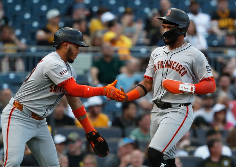 May 21, 2024; Pittsburgh, Pennsylvania, USA;  San Francisco Giants second baseman Thairo Estrada (left) and center fielder Luis Matos (right) celebrate after both players scored runs against the Pittsburgh Pirates during the first inning at PNC Park. Mandatory Credit: Charles LeClaire-USA TODAY Sports