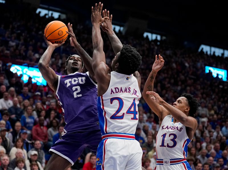 Jan 6, 2024; Lawrence, Kansas, USA; TCU Horned Frogs forward Emanuel Miller (2) shoots against Kansas Jayhawks forward K.J. Adams Jr. (24) and guard Elmarko Jackson (13) during the first half at Allen Fieldhouse. Mandatory Credit: Jay Biggerstaff-USA TODAY Sports