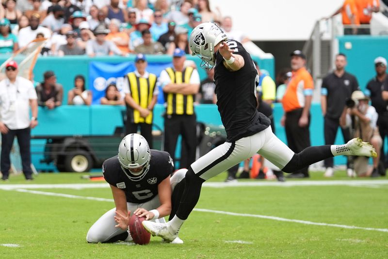 Las Vegas Raiders place kicker Daniel Carlson (2) kicks a field goal during the first half of an NFL football game against the Miami Dolphins, Sunday, Nov. 17, 2024, in Miami Gardens, Fla. (AP Photo/Rebecca Blackwell)