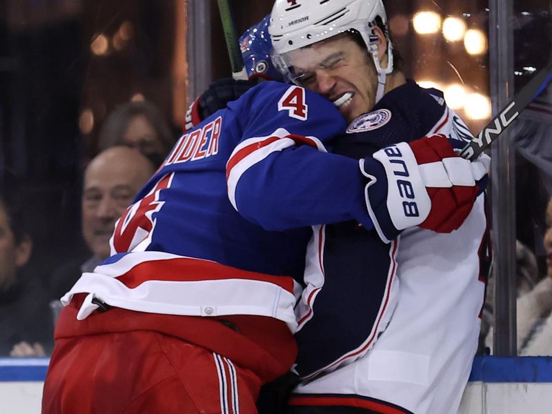 Feb 28, 2024; New York, New York, USA; New York Rangers defenseman Braden Schneider (4) checks Columbus Blue Jackets center Cole Sillinger (4) into the boards during the third period at Madison Square Garden. Mandatory Credit: Brad Penner-USA TODAY Sports