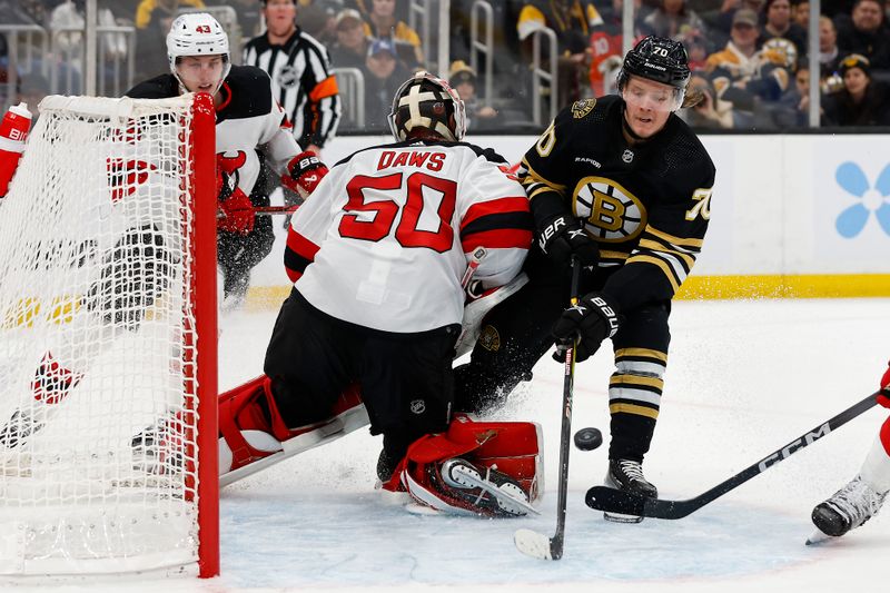 Jan 15, 2024; Boston, Massachusetts, USA; Boston Bruins center Jesper Boqvist (70) collides with New Jersey Devils goaltender Nico Daws (50) going for a loose puck during the third period at TD Garden. Mandatory Credit: Winslow Townson-USA TODAY Sports