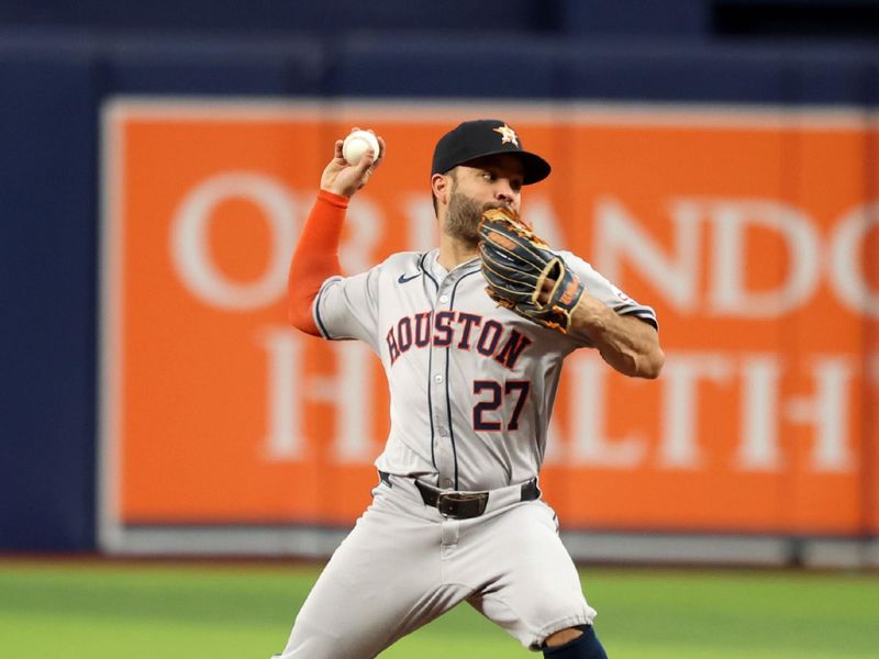 Aug 14, 2024; St. Petersburg, Florida, USA; Houston Astros second base Jose Altuve (27) forces out and throws the ball to first base for a double play against the Tampa Bay Rays during the first inning at Tropicana Field. Mandatory Credit: Kim Klement Neitzel-USA TODAY Sports