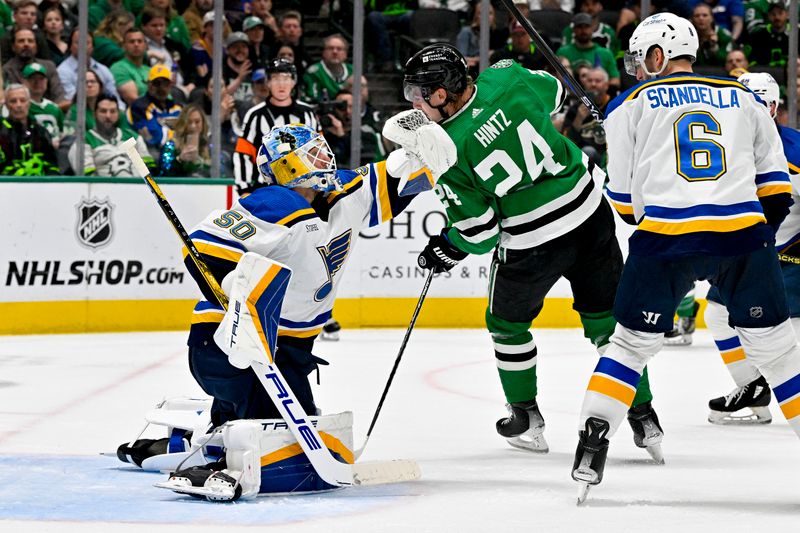 Apr 17, 2024; Dallas, Texas, USA; St. Louis Blues goaltender Jordan Binnington (50) makes a glove save in front of Dallas Stars center Roope Hintz (24) during the second period at the American Airlines Center. Mandatory Credit: Jerome Miron-USA TODAY Sports