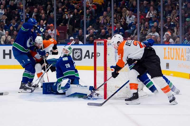 Dec 28, 2023; Vancouver, British Columbia, CAN; Vancouver Canucks goalie Casey DeSmith (29) makes a save on Philadelphia Flyers forward Scott Laughton (21) in the first period at Rogers Arena. Mandatory Credit: Bob Frid-USA TODAY Sports