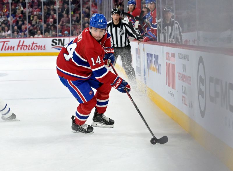 Apr 6, 2024; Montreal, Quebec, CAN; Montreal Canadiens forward Nick Suzuki (14) plays the puck during the third period of the game against the Toronto Maple Leafs at the Bell Centre. Mandatory Credit: Eric Bolte-USA TODAY Sports