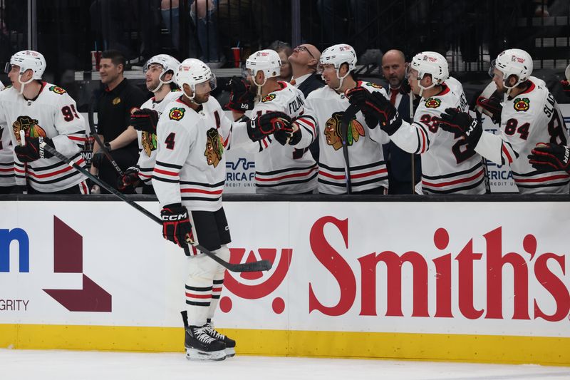 Feb 25, 2025; Salt Lake City, Utah, USA;Chicago Blackhawks defenseman Seth Jones (4) celebrates a goal against the Utah Hockey Club with the bench during the first period at Delta Center. Mandatory Credit: Rob Gray-Imagn Images