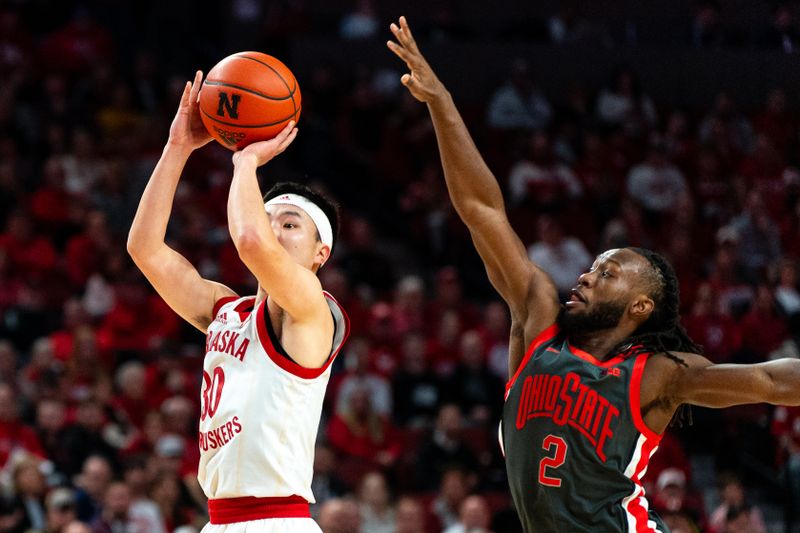 Jan 23, 2024; Lincoln, Nebraska, USA; Nebraska Cornhuskers guard Keisei Tominaga (30) shoots the ball against Ohio State Buckeyes guard Bruce Thornton (2) during the first half at Pinnacle Bank Arena. Mandatory Credit: Dylan Widger-USA TODAY Sports