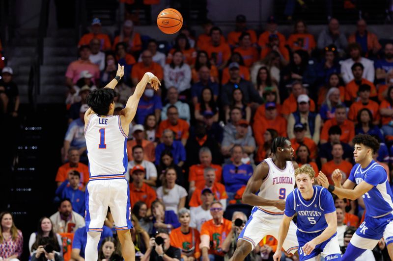 Feb 14, 2026; Gainesville, Florida, USA; Florida Gators guard Xaivian Lee (1) makes a three point basket over Kentucky Wildcats guard Collin Chandler (5) during the first half at Exactech Arena at the Stephen C. O'Connell Center. Mandatory Credit: Matt Pendleton-Imagn Images