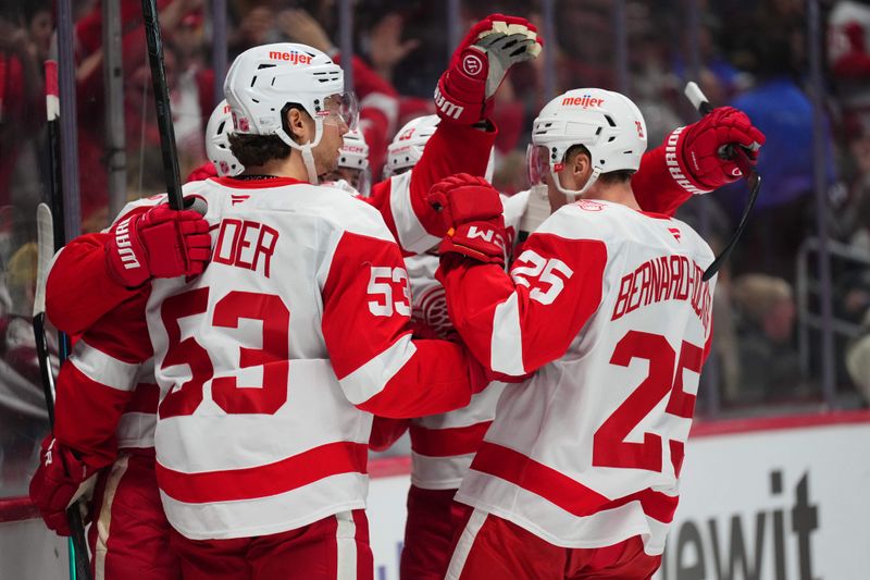 Feb 2, 2026; Denver, Colorado, USA; Members of the Detroit Red Wings celebrate a goal by Detroit Red Wings center Marco Kasper (92) (center) during the first period against the Colorado Avalanche at Ball Arena. Mandatory Credit: Ron Chenoy-Imagn Images