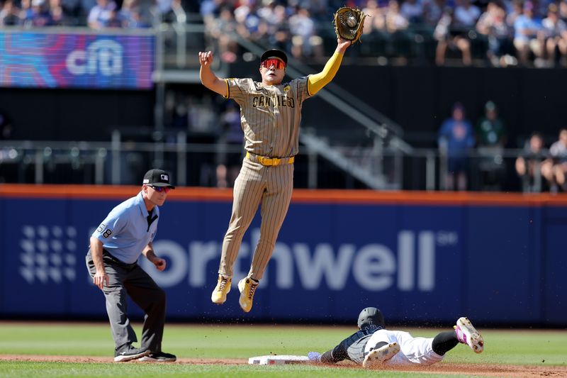 Jun 15, 2024; New York City, New York, USA; New York Mets shortstop Francisco Lindor (12) steals second base as San Diego Padres shortstop Ha-Seong Kim (7) leaps for the ball during the first inning at Citi Field. Mandatory Credit: Brad Penner-USA TODAY Sports