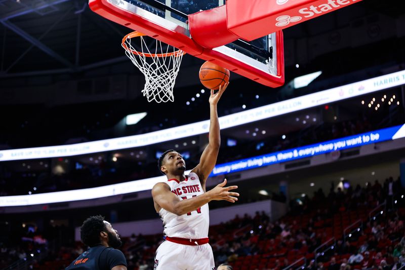 Jan 30, 2024; Raleigh, North Carolina, USA; North Carolina State Wolfpack guard Casey Morsell (14) makes a basket during the first half against Miami (Fl) Hurricanes at PNC Arena. Mandatory Credit: Jaylynn Nash-USA TODAY Sports