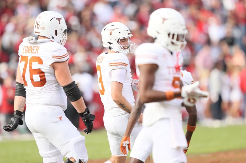 Nov 16, 2024; Fayetteville, Arkansas, USA; Texas Longhorns quarterback Quinn Ewers (3) celebrates after making a final first down to end the game against the Arkansas Razorbacks at Donald W. Reynolds Razorback Stadium. Texas won 20-10. Mandatory Credit: Nelson Chenault-Imagn Images
