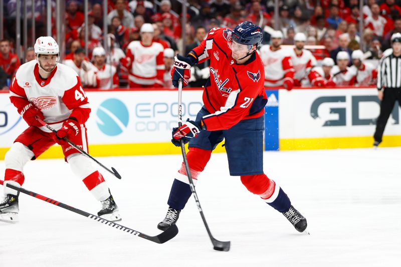 Mar 26, 2024; Washington, District of Columbia, USA; Washington Capitals center Aliaksei Protas (21) shoots the puck past Detroit Red Wings defenseman Shayne Gostisbehere (41) during the third period at Capital One Arena. Mandatory Credit: Amber Searls-USA TODAY Sports