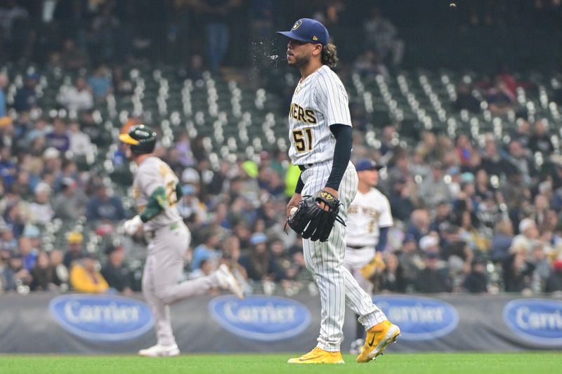 Jun 11, 2023; Milwaukee, Wisconsin, USA; Milwaukee Brewers pitcher Freddy Peralta (51) reacts after giving up a solo home run to Oakland Athletes designated hitter Brent Rooker (25) in the fourth inning at American Family Field. Mandatory Credit: Benny Sieu-USA TODAY Sports