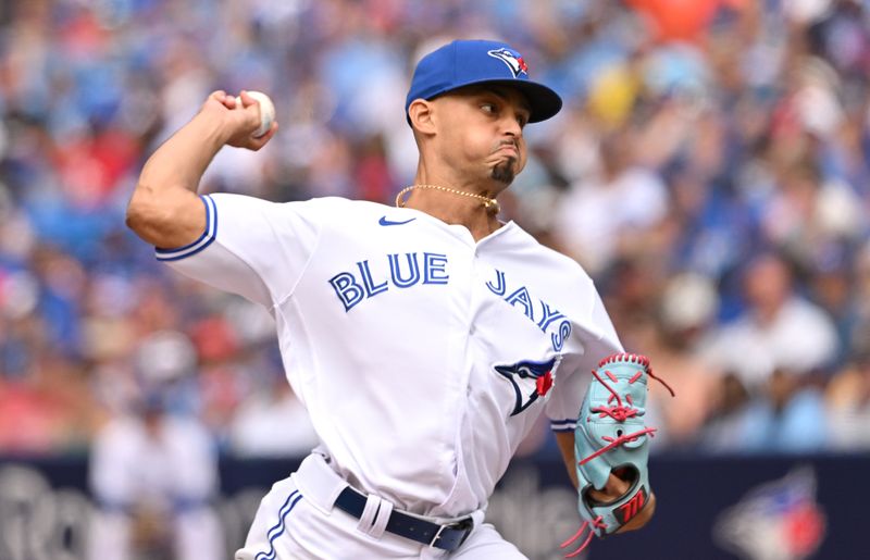 Aug 27, 2023; Toronto, Ontario, CAN;  Toronto Blue Jays relief pitcher Jordan Hicks (12) delivers a pitch against the Cleveland Guardians in the seventh inning at Rogers Centre. Mandatory Credit: Dan Hamilton-USA TODAY Sports