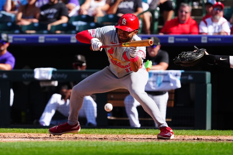 Sep 26, 2024; Denver, Colorado, USA; St. Louis Cardinals center fielder Victor Scott II (11) attempts a bunt sixth inning against the Colorado Rockies at Coors Field. Mandatory Credit: Ron Chenoy-Imagn Images