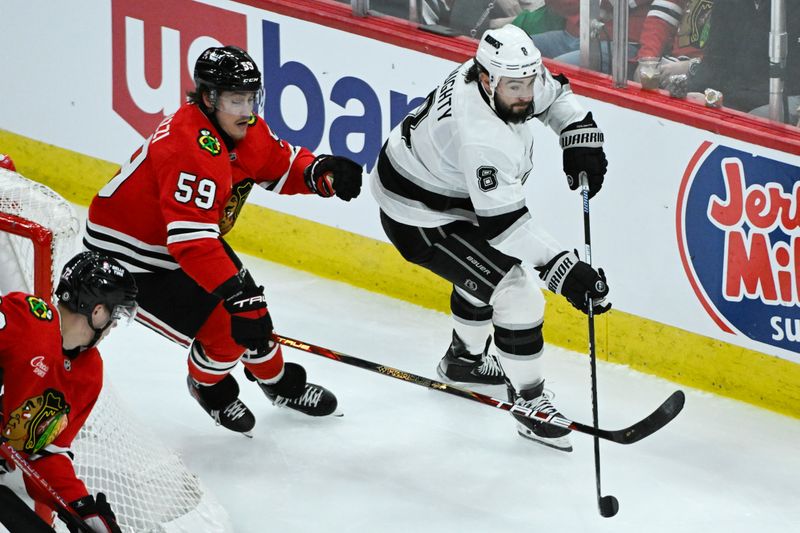 Mar 3, 2025; Chicago, Illinois, USA;  Los Angeles Kings defenseman Drew Doughty (8) moves the puck past Chicago Blackhawks left wing Tyler Bertuzzi (59) during the third period at the United Center. Mandatory Credit: Matt Marton-Imagn Images