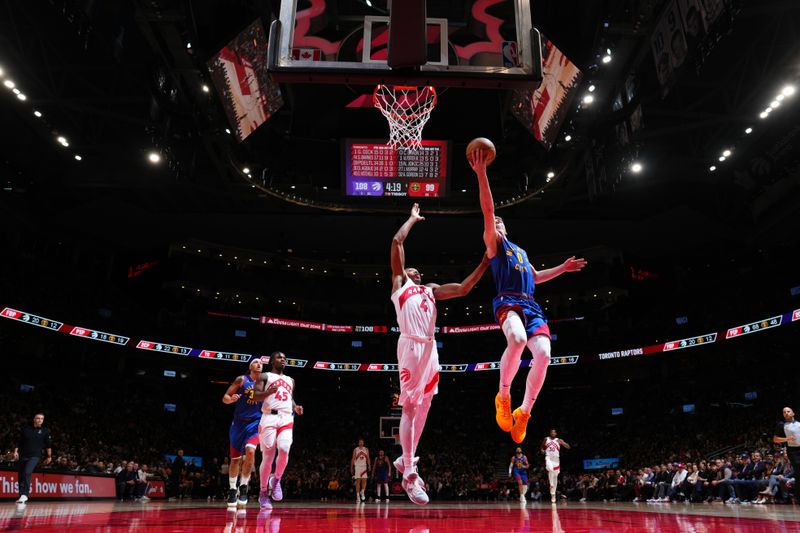 TORONTO, CANADA - OCTOBER 28: Christian Braun #0 of the Denver Nuggets drives to the basket during the game against the Toronto Raptors on October 28, 2024 at the Scotiabank Arena in Toronto, Ontario, Canada.  NOTE TO USER: User expressly acknowledges and agrees that, by downloading and or using this Photograph, user is consenting to the terms and conditions of the Getty Images License Agreement.  Mandatory Copyright Notice: Copyright 2024 NBAE (Photo by Mark Blinch/NBAE via Getty Images)