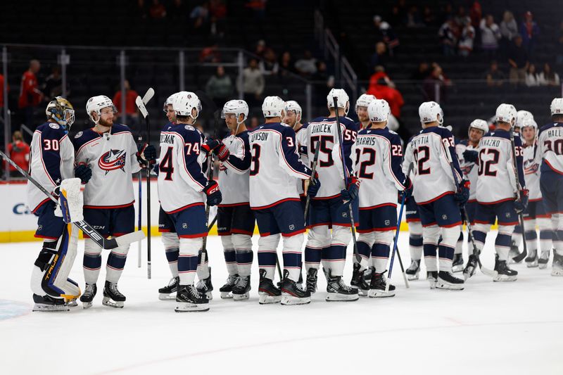 Sep 27, 2024; Washington, District of Columbia, USA; Columbus Blue Jackets players celebrate after their game against the Washington Capitals at Capital One Arena. Mandatory Credit: Geoff Burke-Imagn Images