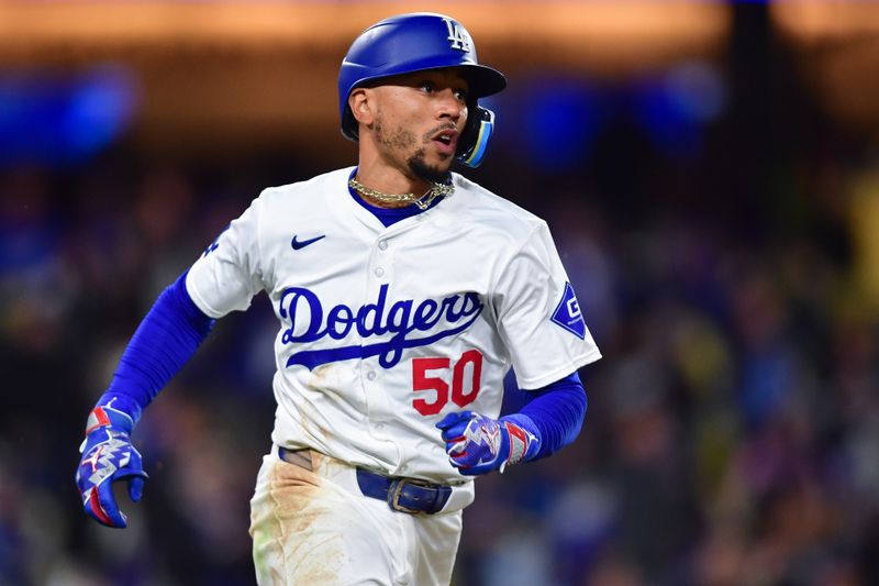 Apr 13, 2024; Los Angeles, California, USA; Los Angeles Dodgers shortstop Mookie Betts (50) runs after hitting an RBI single against the San Diego Padres during the sixth inning at Dodger Stadium. Mandatory Credit: Gary A. Vasquez-USA TODAY Sports