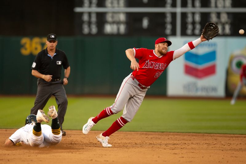 Jul 3, 2024; Oakland, California, USA; Oakland Athletics catcher Shea Langeliers (23) slides safely into second base with a steal as Los Angeles Angels second baseman Brandon Drury (23) reaches for the errant throw during the sixth inning at Oakland-Alameda County Coliseum. Mandatory Credit: D. Ross Cameron-USA TODAY Sports