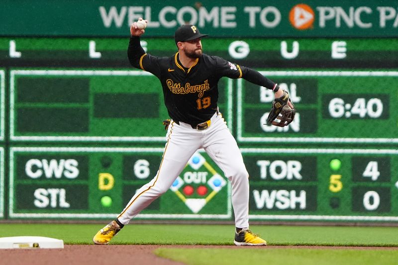 May 4, 2024; Pittsburgh, Pennsylvania, USA; Pittsburgh Pirates second baseman Jared Triolo (19) throws out Colorado Rockies catcher Elias Diaz (not pictured) after fielding a ground ball during the seventh inning at PNC Park. Mandatory Credit: Gregory Fisher-USA TODAY Sports