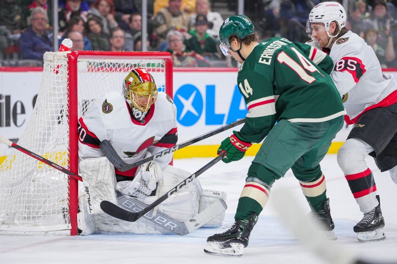 Apr 2, 2024; Saint Paul, Minnesota, USA; Ottawa Senators goaltender Joonas Korpisalo (70) makes a save in front of Minnesota Wild center Joel Eriksson Ek (14) in the second period at Xcel Energy Center. Mandatory Credit: Brad Rempel-USA TODAY Sports