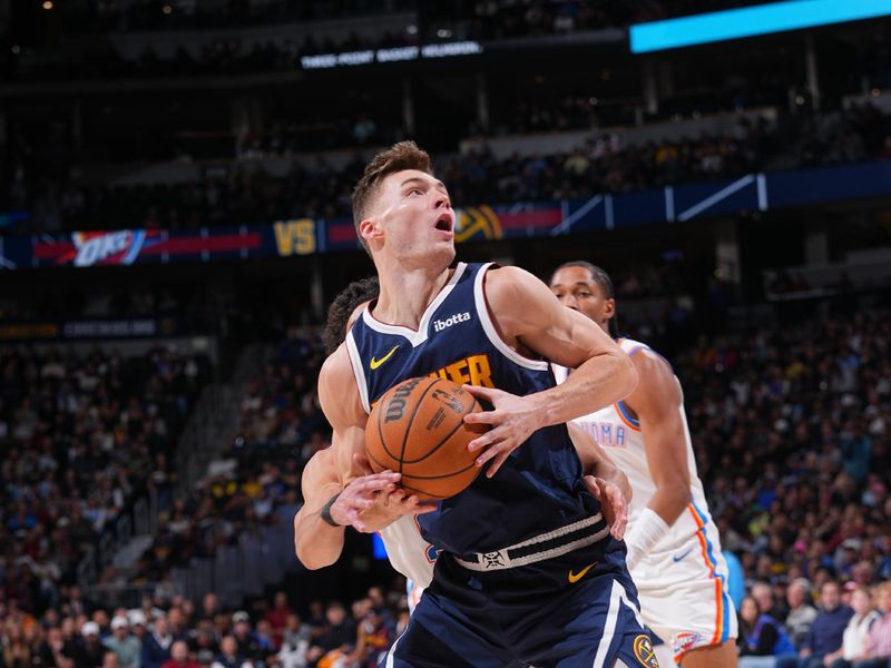 DENVER, CO - NOVEMBER 6: Christian Braun #0 of the Denver Nuggets drives to the basket during the game against the Oklahoma City Thunder during a regular season game on November 6, 2024 at Ball Arena in Denver, Colorado. NOTE TO USER: User expressly acknowledges and agrees that, by downloading and/or using this Photograph, user is consenting to the terms and conditions of the Getty Images License Agreement. Mandatory Copyright Notice: Copyright 2024 NBAE (Photo by Bart Young/NBAE via Getty Images)