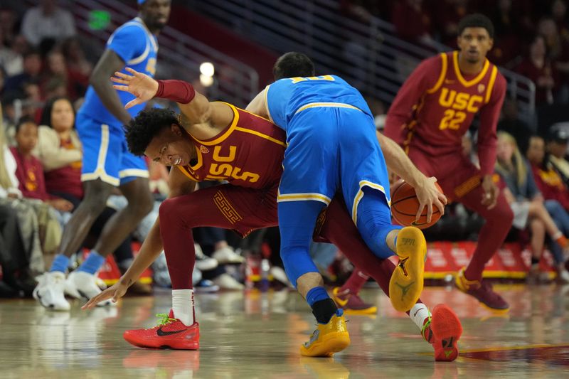 Jan 27, 2024; Los Angeles, California, USA; UCLA Bruins guard Lazar Stefanovic (10) collides with Southern California Trojans guard Boogie Ellis (5) in the second half at Galen Center. Mandatory Credit: Kirby Lee-USA TODAY Sports