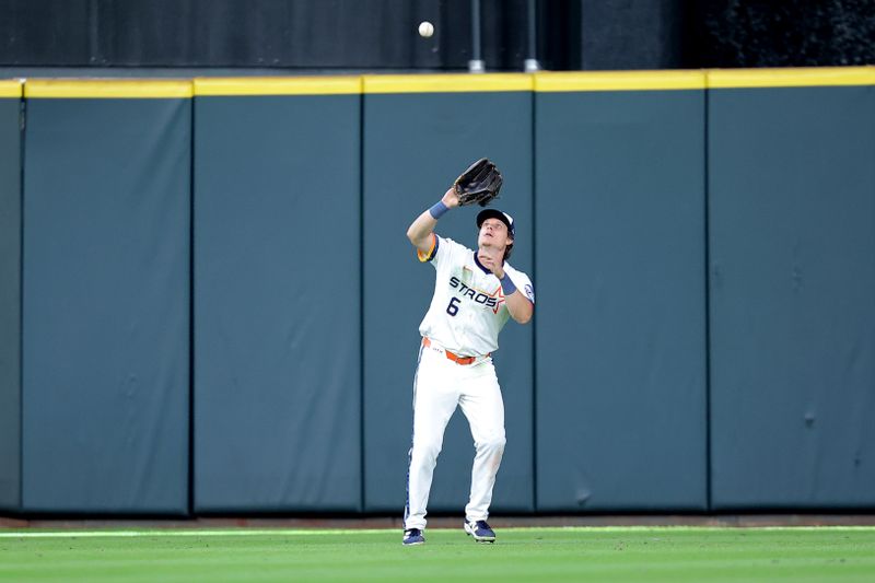 Apr 13, 2025; Houston, Texas, USA; Houston Astros center fielder Jake Meyers (6) reaches up to catch a fly ball for the final out against the Los Angeles Angels during the ninth inning at Daikin Park. Mandatory Credit: Erik Williams-Imagn Images