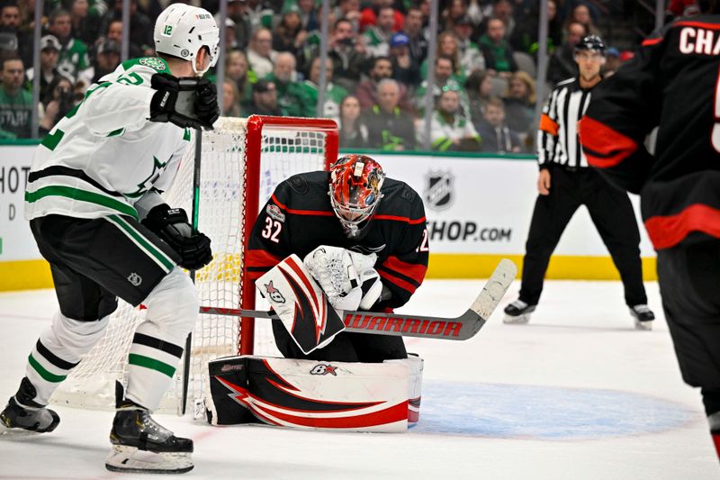 Jan 25, 2023; Dallas, Texas, USA; Carolina Hurricanes goaltender Antti Raanta (32) covers up the puck as Dallas Stars center Radek Faksa (12) looks for the rebound during the second period at the American Airlines Center. Mandatory Credit: Jerome Miron-USA TODAY Sports