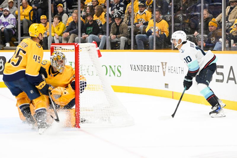 Oct 15, 2024; Nashville, Tennessee, USA;  Seattle Kraken center Matty Beniers (10) looks at the offense from behind the net against the Nashville Predators during the second period at Bridgestone Arena. Mandatory Credit: Steve Roberts-Imagn Images