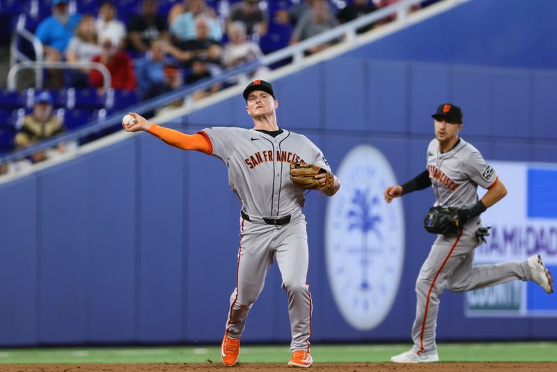 Apr 17, 2024; Miami, Florida, USA; San Francisco Giants third baseman Matt Chapman (26) throws to first base and retires Miami Marlins shortstop Otto Lopez (not pictured) during the second inning at loanDepot Park. Mandatory Credit: Sam Navarro-USA TODAY Sports