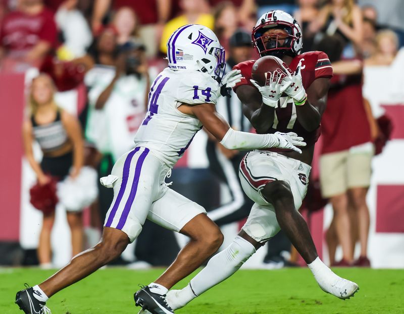 Sep 9, 2023; Columbia, South Carolina, USA; South Carolina Gamecocks wide receiver Xavier Legette (17) makes a 42-yard touchdown reception over Furman Paladins cornerback Micah Robinson (14) during the third quarter at Williams-Brice Stadium. Mandatory Credit: Jeff Blake-USA TODAY Sports