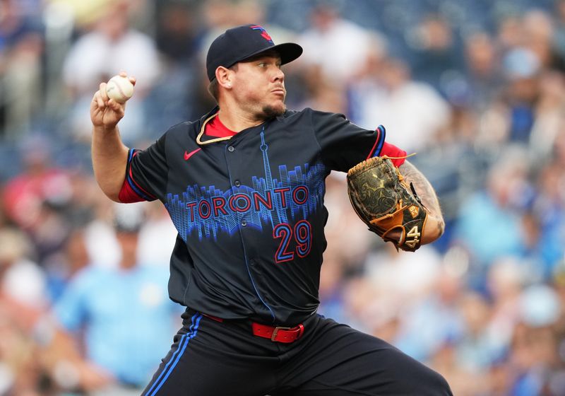 Jul 24, 2024; Toronto, Ontario, CAN; Toronto Blue Jays starting pitcher Yariel Rodriguez (29) throws a pitch against the Tampa Bay Rays during the first inning at Rogers Centre. Mandatory Credit: Nick Turchiaro-USA TODAY Sports