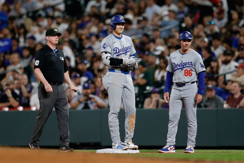 Sep 27, 2024; Denver, Colorado, USA; Los Angeles Dodgers designated hitter Shohei Ohtani (17) on first ahead of umpire Ryan Willis (20) and first base coach Clayton McCullough (86) after hitting a single in the fourth inning against the Colorado Rockies at Coors Field. Mandatory Credit: Isaiah J. Downing-Imagn Images