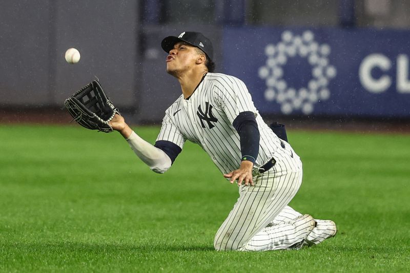 Aug 8, 2024; Bronx, New York, USA;  New York Yankees right fielder Juan Soto (22) falls down while making a catch on a fly ball in the ninth inning against the Los Angeles Angels at Yankee Stadium. Mandatory Credit: Wendell Cruz-USA TODAY Sports
