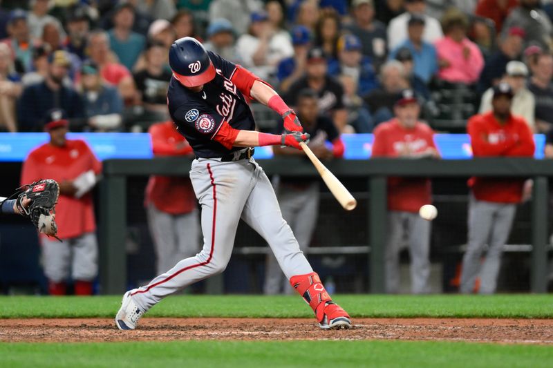 Jun 27, 2023; Seattle, Washington, USA; Washington Nationals right fielder Lane Thomas (28) hits a two run RBI double against the Seattle Mariners during the eleventh inning at T-Mobile Park. Mandatory Credit: Steven Bisig-USA TODAY Sports