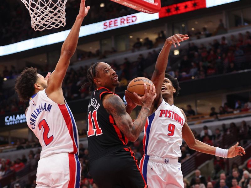 CHICAGO, ILLINOIS - FEBRUARY 27: DeMar DeRozan #11 of the Chicago Bulls goes up for a layup against Cade Cunningham #2 of the Detroit Pistons during the first half at the United Center on February 27, 2024 in Chicago, Illinois. NOTE TO USER: User expressly acknowledges and agrees that, by downloading and or using this photograph, User is consenting to the terms and conditions of the Getty Images License Agreement. (Photo by Michael Reaves/Getty Images)